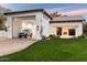 Stylish exterior showcasing a large garage, fireplace, pristine lawn, and beautiful architectural details at 13670 N 85Th Pl, Scottsdale, AZ 85260