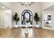 Elegant foyer with a decorative table, hardwood floors, designer lighting, and beautiful architectural details at 13670 N 85Th Pl, Scottsdale, AZ 85260