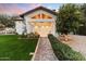 Charming home entrance with a walkway leading to a spacious garage and lush landscaping at 13670 N 85Th Pl, Scottsdale, AZ 85260