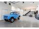 Spacious garage interior with epoxy floors, ample storage, and high ceilings, showcasing a classic blue car at 13670 N 85Th Pl, Scottsdale, AZ 85260