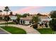 Expansive home featuring a circular driveway, mature landscaping, and a well-manicured lawn at 13670 N 85Th Pl, Scottsdale, AZ 85260