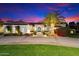 Exterior shot of a home featuring a circular driveway, manicured lawn, and mature landscaping at 13670 N 85Th Pl, Scottsdale, AZ 85260