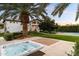 Relaxing hot tub with a large palm tree and the home in the background at 13670 N 85Th Pl, Scottsdale, AZ 85260