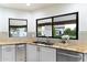 Kitchen featuring granite countertops, stainless steel appliances, and large windows at 13670 N 85Th Pl, Scottsdale, AZ 85260