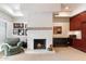 Living room with fireplace, accent lighting, and classic armchair at 13670 N 85Th Pl, Scottsdale, AZ 85260