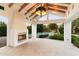 Inviting outdoor living space featuring a fireplace and views of the tennis court at 13670 N 85Th Pl, Scottsdale, AZ 85260