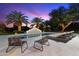 Inviting pool with a water feature, lounge chairs, and palm trees, perfect for relaxation and outdoor enjoyment at 13670 N 85Th Pl, Scottsdale, AZ 85260