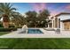 Inviting pool featuring a fountain and surrounded by travertine tile, lush palms, and comfortable lounge chairs at 13670 N 85Th Pl, Scottsdale, AZ 85260