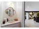 Modern powder room featuring stylish mirror, vanity, and a view to the patio at 13670 N 85Th Pl, Scottsdale, AZ 85260