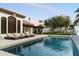 Swimming pool and lounge chairs, set against a backdrop of lush greenery and a well-appointed home at 13670 N 85Th Pl, Scottsdale, AZ 85260