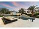 Inviting pool area with elegant lounge seating and lush landscaping, perfect for relaxation at 13670 N 85Th Pl, Scottsdale, AZ 85260