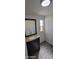 Bathroom showcasing a vanity with granite countertops and a decorative mirror at 1402 S 76Th Pl, Mesa, AZ 85209