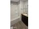 Bathroom features a shower-tub combination and a vanity with granite countertops at 1402 S 76Th Pl, Mesa, AZ 85209