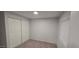 Bedroom features plush carpet, built-in closet space, and natural lighting at 1402 S 76Th Pl, Mesa, AZ 85209
