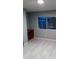 Bedroom featuring new laminate flooring and a window for natural light at 1402 S 76Th Pl, Mesa, AZ 85209