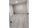 Bright bedroom with gray flooring, a window and a door, offering a modern look at 1402 S 76Th Pl, Mesa, AZ 85209