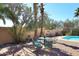 Relax by the pool in this backyard oasis, surrounded by lush landscaping and mature trees at 14460 N 100Th Way, Scottsdale, AZ 85260