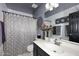 Updated bathroom showcasing a vanity, patterned shower curtain, and modern fixtures at 14460 N 100Th Way, Scottsdale, AZ 85260