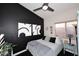 Stylish bedroom featuring a dark accent wall and modern decor at 14460 N 100Th Way, Scottsdale, AZ 85260