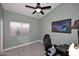 Comfortable bedroom with neutral walls, ceiling fan, and bright window at 14460 N 100Th Way, Scottsdale, AZ 85260