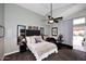 Cozy bedroom featuring a ceiling fan, plush carpet, and ensuite bathroom at 14460 N 100Th Way, Scottsdale, AZ 85260