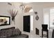 The bright foyer offers a decorative light fixture, decor, and a black front door at 14460 N 100Th Way, Scottsdale, AZ 85260