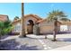 Charming home featuring desert landscaping with rock cover, mature palm trees, and tile roof at 14460 N 100Th Way, Scottsdale, AZ 85260