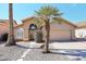 Charming single-story home with desert landscaping, rock cover, and mature palm tree in the front yard at 14460 N 100Th Way, Scottsdale, AZ 85260