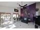 Bright living room with ceiling fan and sliding glass doors leading to a covered patio at 14460 N 100Th Way, Scottsdale, AZ 85260