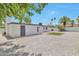 White home boasts a backyard with minimalist landscaping, stone features, and privacy fence at 15032 N 24Th N Pl, Phoenix, AZ 85032