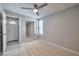 A bright bedroom featuring neutral gray walls, modern ceiling fan, and a closet with mirrored sliding doors at 15032 N 24Th N Pl, Phoenix, AZ 85032