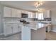 Modern kitchen boasts white cabinets, island, and stainless steel appliances at 15032 N 24Th N Pl, Phoenix, AZ 85032