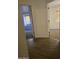 Hallway with wood-look tile flooring leading to bedrooms with carpet and natural light at 1688 E Krystal St, Casa Grande, AZ 85122