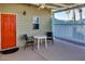 Cozy patio featuring a bright orange door, quaint seating, and a refreshing outdoor ambiance at 17200 W Bell Rd # 357, Surprise, AZ 85374