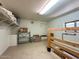 Storage area features shelving, an access door, a window, and open storage spaces at 17200 W Bell Rd # 357, Surprise, AZ 85374