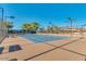 Active tennis court with blue surface, benches, and shade trees behind the fence at 17200 W Bell Rd # 357, Surprise, AZ 85374