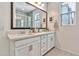 Bathroom features a double sink vanity with quartz countertops and a large mirror with natural lighting at 1724 E Bridgeport Pkwy, Gilbert, AZ 85295