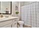 Clean bathroom with a modern vanity, shower with patterned curtain, and stylish decor at 1724 E Bridgeport Pkwy, Gilbert, AZ 85295