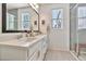 Bright bathroom featuring a double sink vanity with modern fixtures and a walk-in shower with glass enclosure at 1724 E Bridgeport Pkwy, Gilbert, AZ 85295