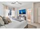 Calm bedroom with neutral decor, ceiling fan, and natural light from the window at 1724 E Bridgeport Pkwy, Gilbert, AZ 85295