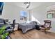 Well-lit bedroom featuring a desk, ceiling fan, and comfortable chair at 1724 E Bridgeport Pkwy, Gilbert, AZ 85295