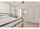 Bright bedroom featuring a black metal bed frame, clean white walls, and ample natural light at 1724 E Bridgeport Pkwy, Gilbert, AZ 85295