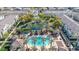 Aerial view of a community showcasing pool, pond, green spaces, and residential buildings at 1724 E Bridgeport Pkwy, Gilbert, AZ 85295