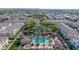 An aerial shot displays a vibrant community featuring a pool, pond, trees, and townhouses at 1724 E Bridgeport Pkwy, Gilbert, AZ 85295