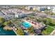 Aerial view capturing a community featuring a pool, pond, lush greenery, and residential buildings at 1724 E Bridgeport Pkwy, Gilbert, AZ 85295