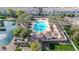 An aerial view of a pool and pond surrounded by palms and lush landscaping in a community at 1724 E Bridgeport Pkwy, Gilbert, AZ 85295