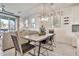 Well-lit dining area with a modern table, stylish chairs, and a view of the living space and outdoor balcony at 1724 E Bridgeport Pkwy, Gilbert, AZ 85295