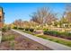 Community walkway with landscaped shrubbery, lush trees and well-maintained lawn at 1724 E Bridgeport Pkwy, Gilbert, AZ 85295