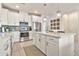 Bright kitchen with white cabinetry, stainless steel appliances, and a large island with pendant lighting at 1724 E Bridgeport Pkwy, Gilbert, AZ 85295