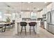 Well-lit kitchen showcases an island with barstools, modern appliances, and an open design for easy entertaining at 1724 E Bridgeport Pkwy, Gilbert, AZ 85295